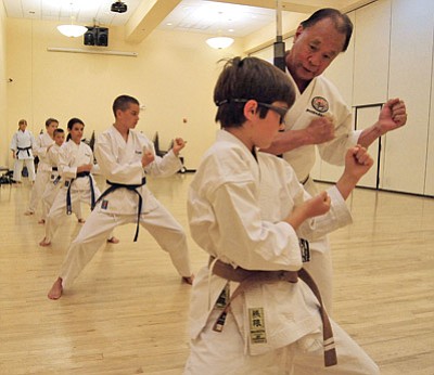 Matt Hinshaw/The Daily Courier<br>Sensei Victor Young works with his student Johnny DeCarlo, 12, during his kids’ karate class at the Prescott Adult Center on Thursday, June 5.