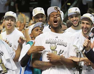 David J. Phillip/The Associated Press<br>
Most Valuable Player San Antonio Spurs forward Kawhi Leonard, third from right, celebrates after Game 5 of the NBA basketball finals against the Miami Heat on Sunday in San Antonio. The Spurs won the NBA championship 104-87.