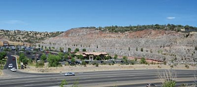 Les Stukenberg/The Daily Courier<br>A view of the cliffside from the south side of Highway 69 where the proposed Touchmark at the Ranch senior apartment complex will be located.