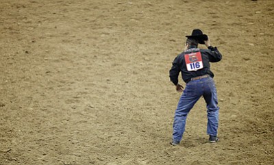 Isaac Brekken/The Associated Press<br>Luke Branquinho performs his signature move after the steer wresting competition during the ninth go-round of the National Finals Rodeo on Dec. 13, 2013, in Las Vegas.