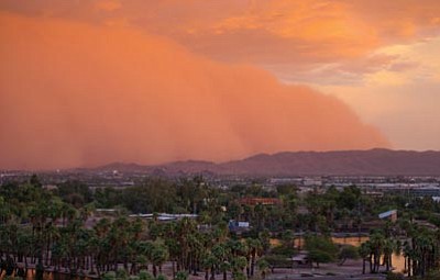 Patrick Breen/The Associated Press<br>
A dust storm moves through Phoenix Thursday.

