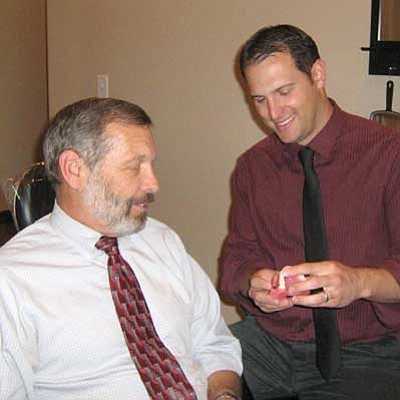 Courtesy photo<br>
Dr. Paul Wulff and his son, Aaron, share a moment with a set of teeth.