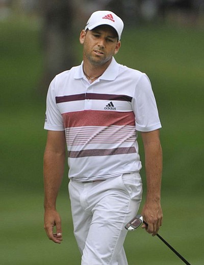 Phil Long/The Associated Press<br> Sergio Garcia reacts after missing a birdie putt on the 13th hole during Saturday’s third round of the Bridgestone Invitational in Akron.