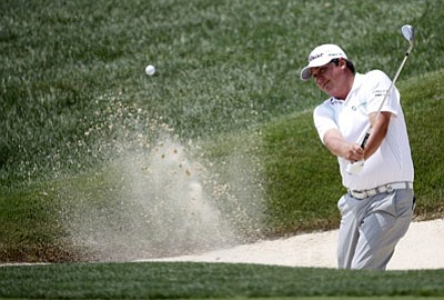 Mike Groll/The Associated Press<br>Jason Dufner hits out of a bunker during a practice round for the PGA Championship at Valhalla Golf Club on Wednesday.