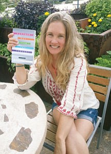 Patrick Whitehurst/The Daily Courier<br>
Michaela Carter, co-owner of the Peregrine Book Company in Prescott and a creative writing instructor at Yavapai College, celebrates the nationwide release of her book “Further Out Than You Thought.”

