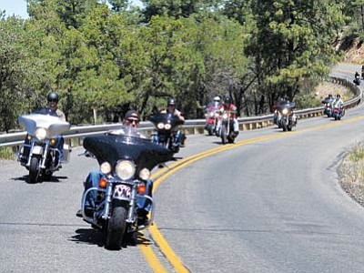 Motorcycle riders enjoy a cruise on a road south of Prescott, some with helmets, some without. (The Daily Courier/file)