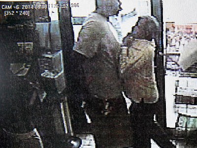 An image from security camera footage reportedly shows Michael Brown assaulting a store employee shortly before being fatally shot by a police officer in Ferguson, Mo. A report released Friday by Ferguson Police Chief Thomas Jackson says that Brown and his friend, Dorian Johnson, stole a box of cigars from the store. (Ferguson Police Department/The Associated Press)