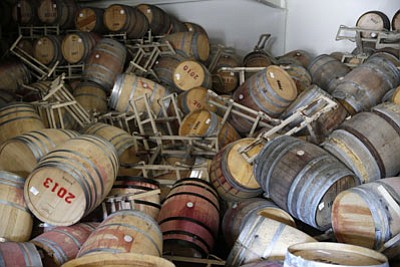 Eric Risberg/AP<br> 
Barrels filled with Cabernet Sauvignon are toppled on one another after an earthquake at the B.R. Cohn Winery barrel storage facility on Sunday in Napa, Calif 
