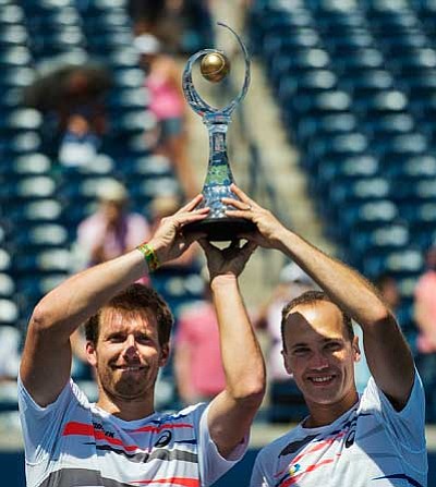 Alexander Peya of Austria, left, holds up the doubles trophy with his partner Bruno Soares of Brazil during the Rogers Cup tennis tournament men's doubles final in Toronto on Aug. 10. (AP Photo/The Canadian Press, Aaron Vincent Elkaim)