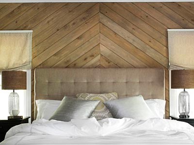 In this photo provided by courtesy of Wood, Naturally and Woodnaturally.com, to add texture and pattern to this master bedroom, designer Brian Patrick Flynn and Wood, Naturally spokesperson Dan Faires outfitted one wall with cedar planks installed in a geometric pattern. Flynn and Faires suggest using softwoods for both interior and exterior applications as they are more readily available and often much more affordable than exotic woods. (Associated Press photo/Wood, Naturally)