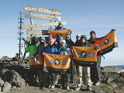 Members of the Elisha Foundation’s hiking group, including Prescott Valley 13-year-old Micah Reimer, reach the summit of Kilimanjaro during this summer’s trek to raise awareness for the disabled. (Courtesy photo)