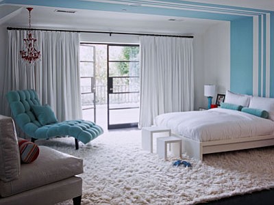 In this photo, designer Betsy Burnham filled this bedroom for a preteen girl with white bedding, a white rug and chair and white curtains, then added just one piece of furniture, a bit of paint and a few accessories in the girl’s current favorite color. The room can easily (and affordably) take on a new look if her taste in colors changes as she grows. (Associated Press photo)