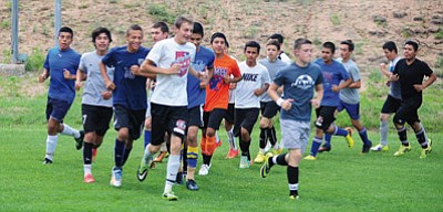 Les Stukenberg/The Daily Courier<br>The Cougars run a lap before practice on Aug. 20 in Chino Valley. Last fall the team won the program’s third AIA state championship.