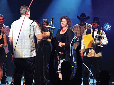 Erin Johnson accepts the first place trophy after winning the fifth annual Prescott Idol finale Thursday night at the Yavapai College Performance Hall in Prescott. (Matt Hinshaw/The Daily Courier)