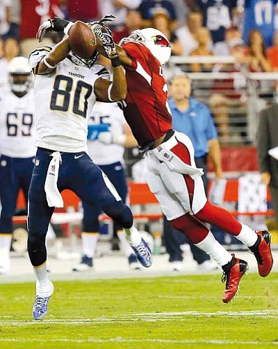 Rick Scuteri/The Associated Press<br>Cardinals cornerback Antonio Cromartie breaks up a pass intended for San Diego’s Malcom Floyd Monday night in Glendale.