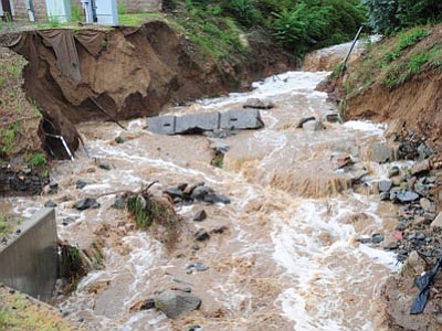 The wash along Holiday Drive in Prescott runs hard after intense rains last month. (Les Stukenberg/The Daily Courier)