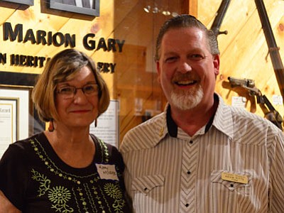 Karen Despain/The Daily Courier<br>
Kathy McCrain, whose father Bill Gary was inducted into the Arizona Rancher and Cowboy Hall of Fame at the event, poses with Phippen Board of Trustee Chair Kevin Pitts Saturday night at the Phippen Museum’s annual Fall Gathering.