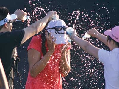 Montgomery Advertiser, Lloyd Gallman/The AP<br>
Ricky Hur, left, brother, and Cherie Hur, right, sister-in-law, pour water on Mi Jung Hur after she won the LPGA Classic golf tournament at Capitol Hill on Sunday.
