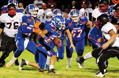 Les Stukenberg/The Daily Courier<br>Jared Chavez (26) looks for a seam through heavy traffic as the Cougars hosted Combs Friday night in Chino Valley.