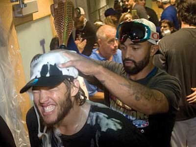 The Associated Press<br>
Matt Kemp pours champagne over Clayton Kershaw’s head in celebration of the Dodgers clinching the National League West against the San Francisco Giants at Dodger Stadium.