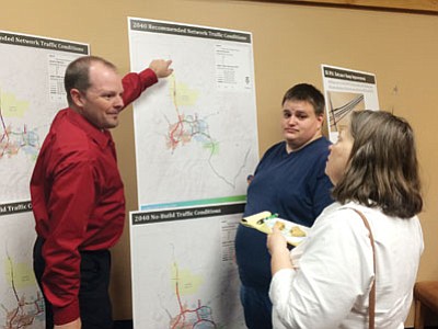 Central Yavapai Metropolitan Planning Organization Administrator Chris Bridges, left, discusses highway plans in the Paulden area with Paulden Area Community Organization Board Member George Anderson and PACO President Jane Anderson. (Cindy Barks/The Daily Courier)