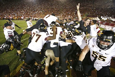 Rob Schumacher/The Arizona Republic, AP<br>ASU goes crazy after Jaelen Strong's 49-yard "Hail Mary" touchdown pass from Mike Bercovici to defeat USC on the final play of the game Saturday at Memorial Coliseum in Los Angeles.