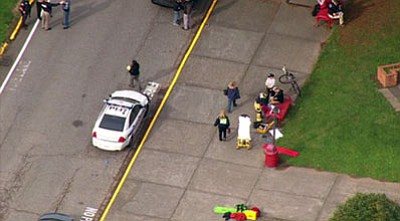 This image made from a video provided by KOMO shows emergency personnel responding after reports of a shooting at Marysville-Pilchuck High School in Marysville, Washington, on Friday. (AP Photo/KOMONews.com)