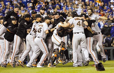 David J. Phillip/The Associated Press<br>The Giants get the party started moments after beating the Royals in Game 7 Wednesday night to clinch their third World Series title in five years.