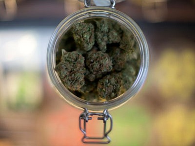 In this Sept. 11, 2014, file photo, a sample of marijuana is shown inside the dispensary at Collective Awakenings in Portland, Ore. (Associated Press photo/The Oregonian, Beth Nakamura, file)