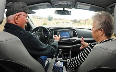 Les Stukenberg/The Daily Courier<br>
Walter and Cathy Anderson decipher their 2015 Highlander’s digital system.