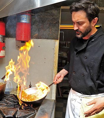 Matt Hinshaw/The Daily Courier<br>
Barry Barbe, owner of El Gato Azul restaurant, cooks up a jalapeno sauce.