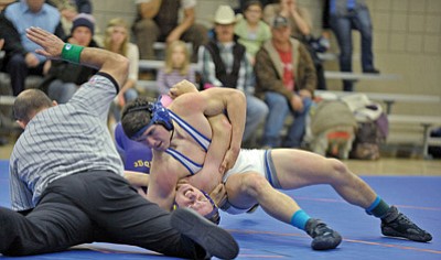 Matt Hinshaw/The Daily Courier<br>The Cougars’ Levi Arce pins Levi Holden of Blue Ridge Wednesday evening at Territorial Elementary School in Chino Valley.