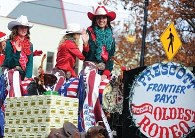 Les Stukenberg/The Daily Courier<br>
Prescott Frontier Days Rodeo Queen Sabrina Swearingin rides with her court in the “150 Years of Christmas Memories”  parade through downtown Prescott Saturday.