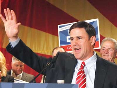 Ross D. Franklin, file/The Associated Press<br>
Doug Ducey, who was elected as Arizona governor, waves to supporters on election night in Phoenix. Ducey will be inaugurated today, Jan. 5.