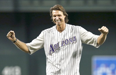 Ross D. Franklin/The Associated Press, file<br>In this May 18, 2014, file photo, former Diamondbacks pitcher Randy Johnson pumps his fists after throwing out the first pitch during ceremonies commemorating the 10th anniversary of his perfect game prior to a game between the Diamondbacks and Dodgers in Phoenix.