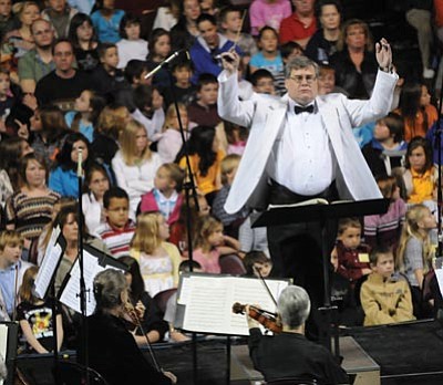 Les Stukenberg/The Daily Courier<br>
Paul Manz conducts the Prescott POPS orchestra for 4,400 students at a Music Memories concert hosted by the Yavapai Symphony Guild at the Prescott Valley Event Center March 2, 2009.
