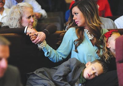Les Stukenberg/The Daily Courier<br>
Andrew Ashcraft’s mother Deborah Pfingston, left, gives support to Juliann Ashcraft, with her son Ryder, during the appeal hearing Wednesday of Granite Mountain Hotshot Andrew Ashcraft’s retirement benefits decision. Presiding Superior Court Judge David L. Mackey ruled against the City of Prescott’s appeal.
