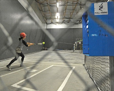 Matt Hinshaw/The Daily Courier<br>Amy Wescott locks in on a softball Thursday afternoon at Full Swing Sports Center in Prescott Valley.