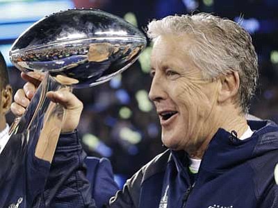 Julio Cortez, File/The Associated Press<br>
Seattle Seahawks coach Pete Carroll holds the Vince Lombardi Trophy after the Seahawks defeated the Denver Broncos 43-8 in Super Bowl XLVIII in East Rutherford, N.J. Carroll's Seahawks will face Bill Belichick's New England Patriots today, Feb. 1, in the Super Bowl with a chance to do something that, for many reasons, was thought to be too tall a task in today's NFL: win a second consecutive championship.