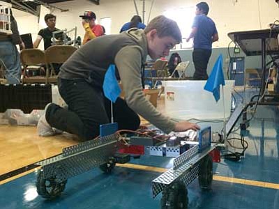 Les Bowen/The Daily Courier<br>
Mile High Middle School seventh-grader Daniel Pietz programs his team’s robot. The Mile High team had to strip this robot when it didn’t meet the size restrictions.
