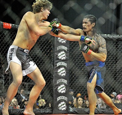 Matt Hinshaw/The Daily Courier<br>Marcus Brodit, right, of Prescott hits Josh Rodda Saturday night during the Rage in the Cage 175 MMA event.