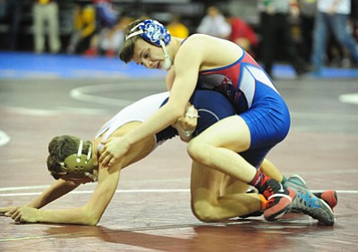 Les Stukenberg/The Daily Courier<br>Camp Verde’s Hayden Uhler, right, pins Austin Blomquist from Yuma Catholic at the Prescott Valley Event Center Thursday night.