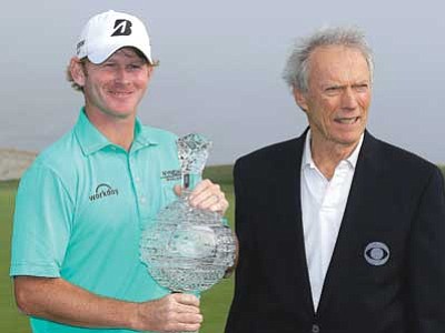 Eric Risberg/The Associated Press<br>
Brandt Snedeker holds his trophy and poses with Clint Eastwood on the 18th green of the Pebble Beach Golf Links after winning the AT&T Pebble Beach National Pro-Am golf tournament Sunday, Feb. 15.