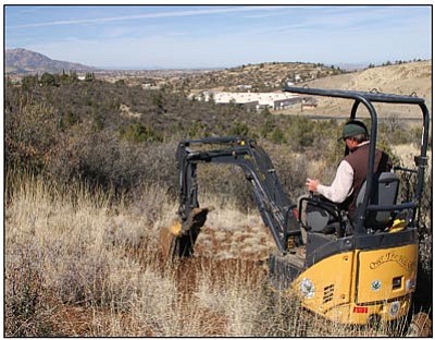 Cindy Barks/The Daily Courier<br>Prescott Trails and Natural Parklands Coordinator Chris Hosking works on the first pass of a trail section overlooking Highway 69 near Badger “P” Mountain. The trail section is among the last remaining gaps in the 55-mile Prescott Circle Trail.