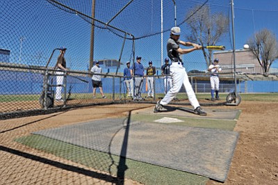 Matt Hinshaw/The Daily Courier<br>Jose Chairez of the Prescott Badgers drives a ball into the outfield during team batting practice Wednesday at PHS.
