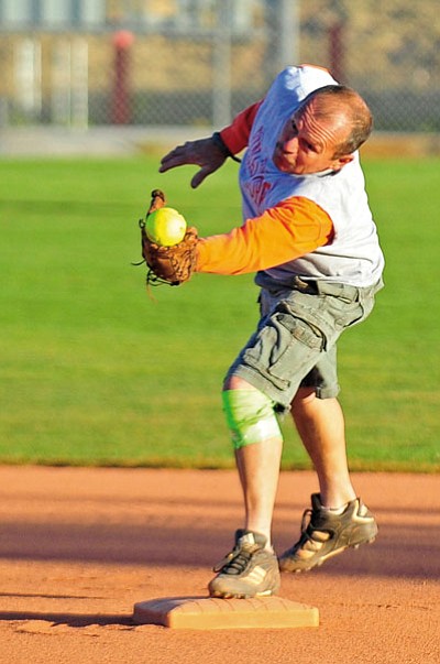 Matt Hinshaw/The Daily Courier<br>Daryl VanKeuren of team Final Score snares a ball back on May 13, 2014, during Senior 50+ recreation softball at Pioneer Park in Prescott.