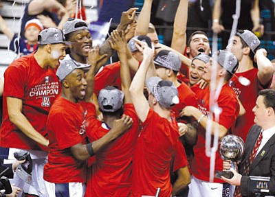 John Locher/The Associated Press<br>Arizona Wildcat players celebrate after beating Oregon 80-52 to clinch the championship of the Pac-12 tournament in easy fashion Saturday night in Las Vegas.