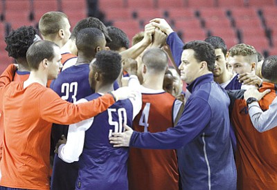 Don Ryan/The Associated Press<br>Arizona coach Sean Miller, front right, and the Wildcats huddle up after practice Wednesday in Portland, Oregon.