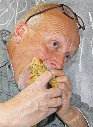 Max Efrein/The Daily Courier. Dave MacKenney eating a hot dog at Nastee Dogs.