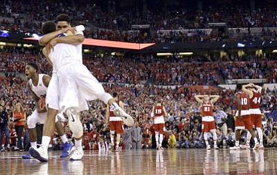 David J. Phillip/The Associated Press<br>Duke players celebrate after the NCAA Final Four tournament championship game against Wisconsin Monday in Indianapolis.